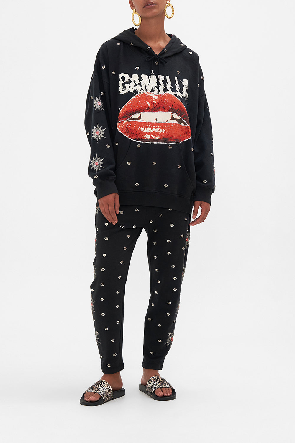 Front view of model wearing CAMILLA black oversized hoodie in Chaos Magic print