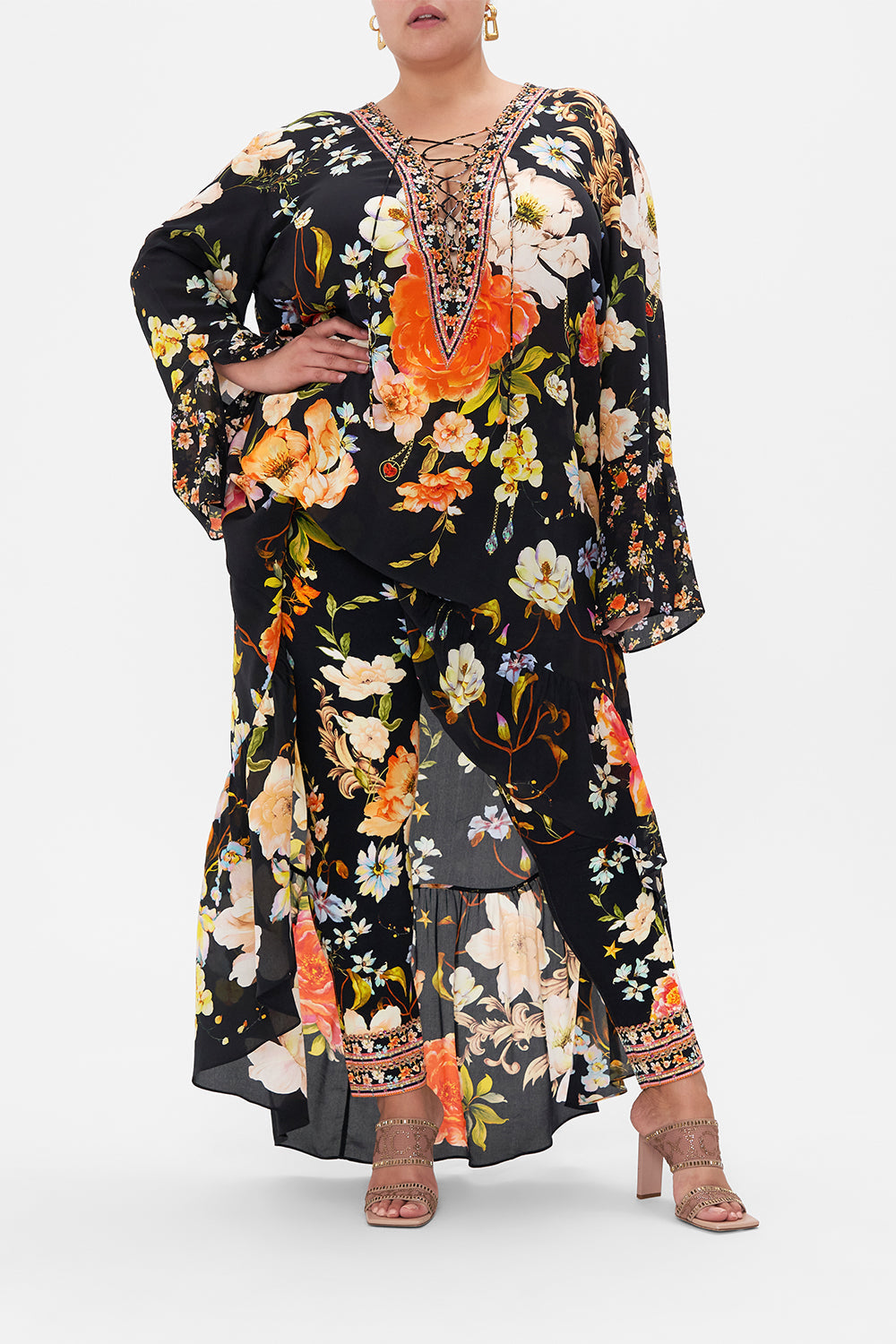 Front view of curvy model wearing CAMILLA plus size floral leggings in Secret History print