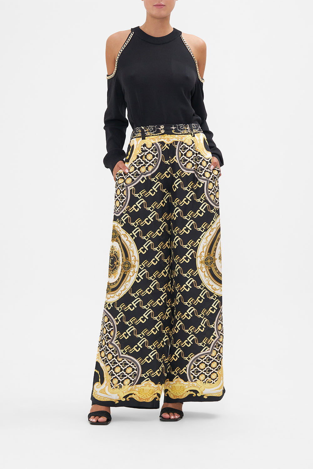 Front view of model wearing CAMILLA black silk pants in Tether Me Not print