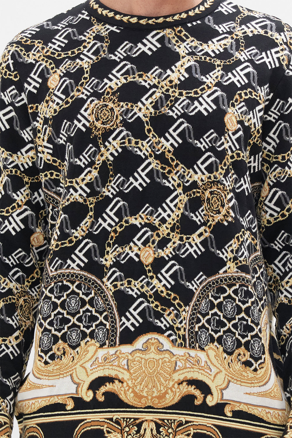 Detail view of model wearing Hotel Franks by CAMILLA mens oversized knit sweater in black and gold Tether Me Not print