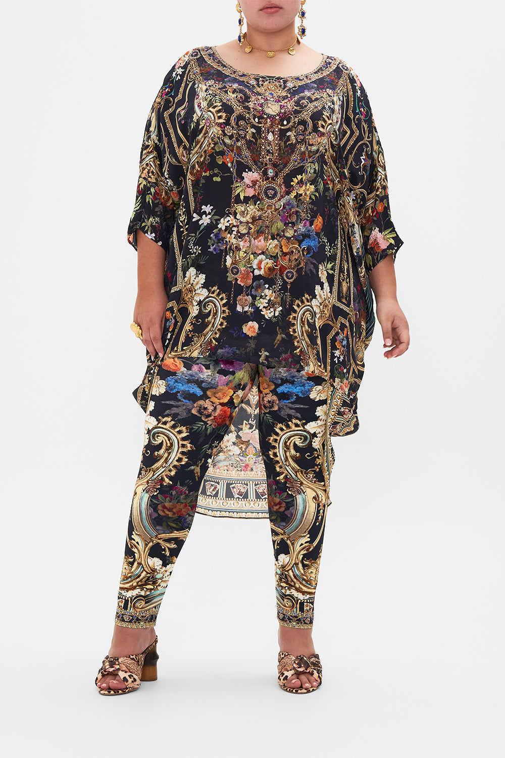 Front view of curvy model wearing CAMILLA plus size floral leggings in Play Your Cards Right print