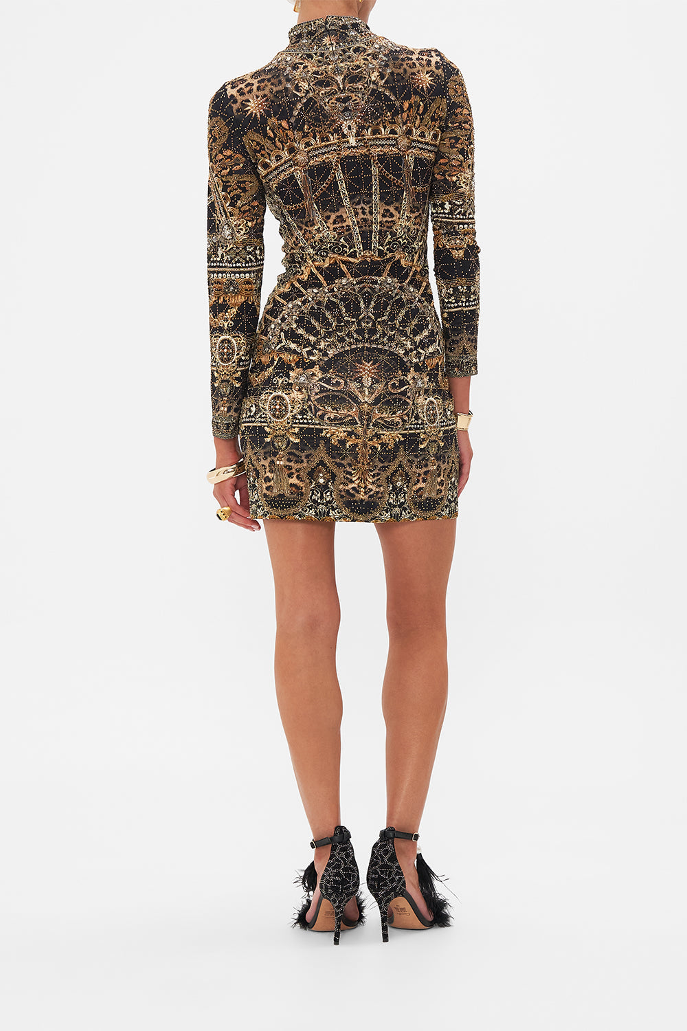 Back view of model wearing CAMILLLA jersey mini dress in Masked At Moonlight print