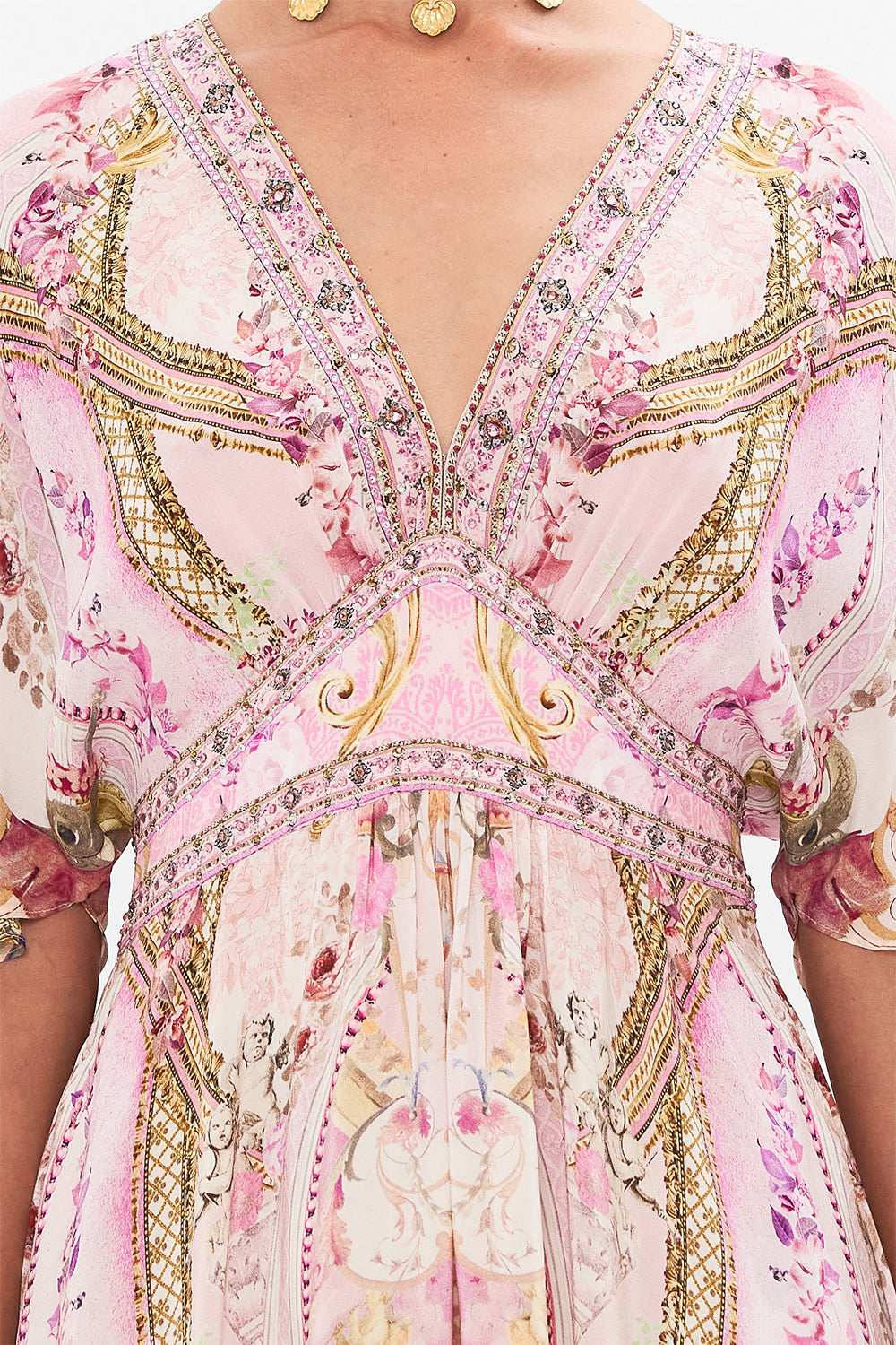 Crop view of model wearing pink silk ruffle dress in Fresco Fairytale print
