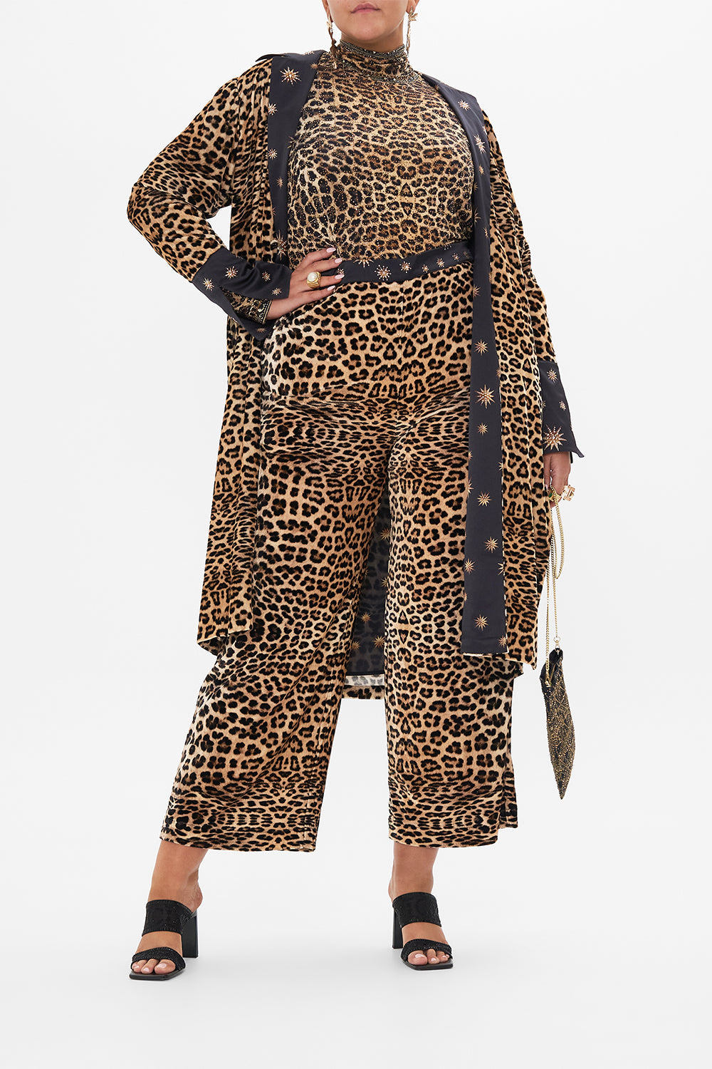 Front view if curvy model wearing CAMILLA plus size leopard print turtleneck top in Soul of A Star Gazer print