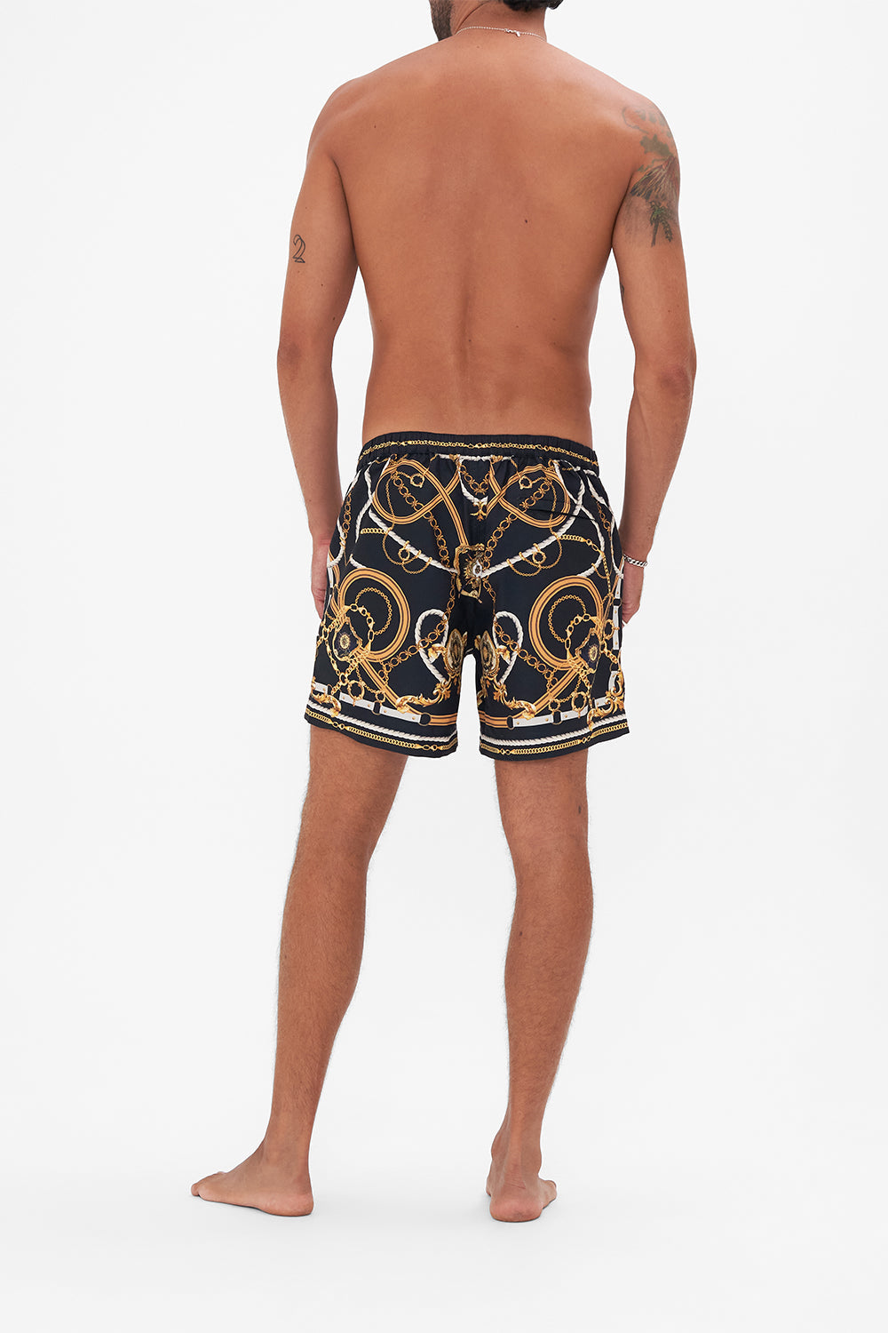 Back view of model wearing Hotel Franks By CAMILLA mens swim short in Coast to Coast print