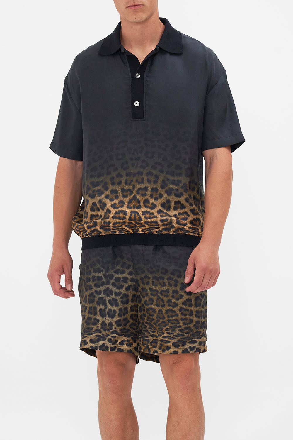 Crop view of model wearing Hotel Franks By CAMILLA mens polo shirt in Masked At Moonlight print