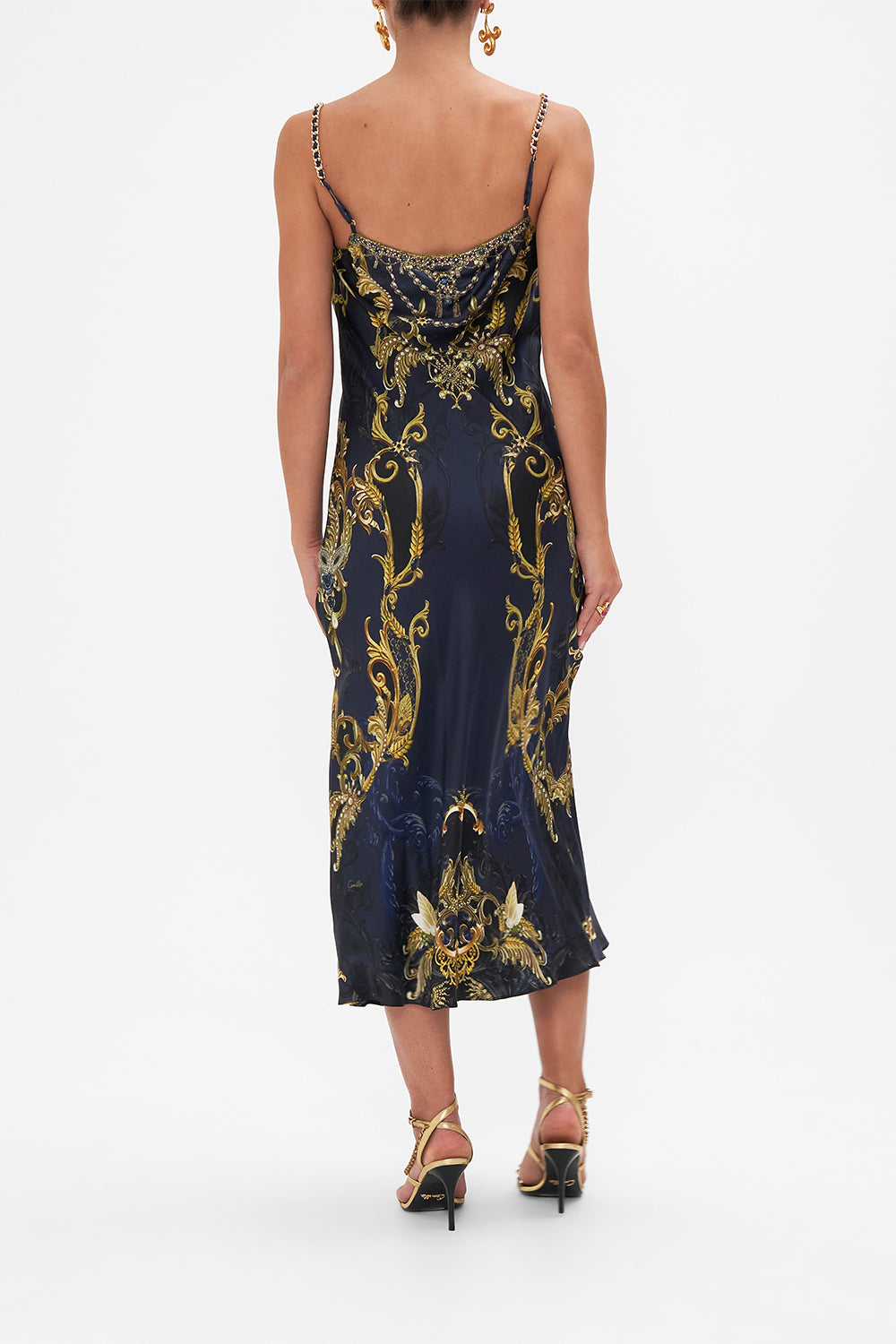 Back view of model wearing CAMILLA bias silk slip dress in Moonlight Melodies print