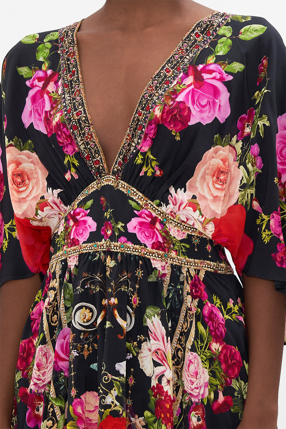 Detail view of model wearing CAMILLAdesigner mini dress in Reservation for Love print