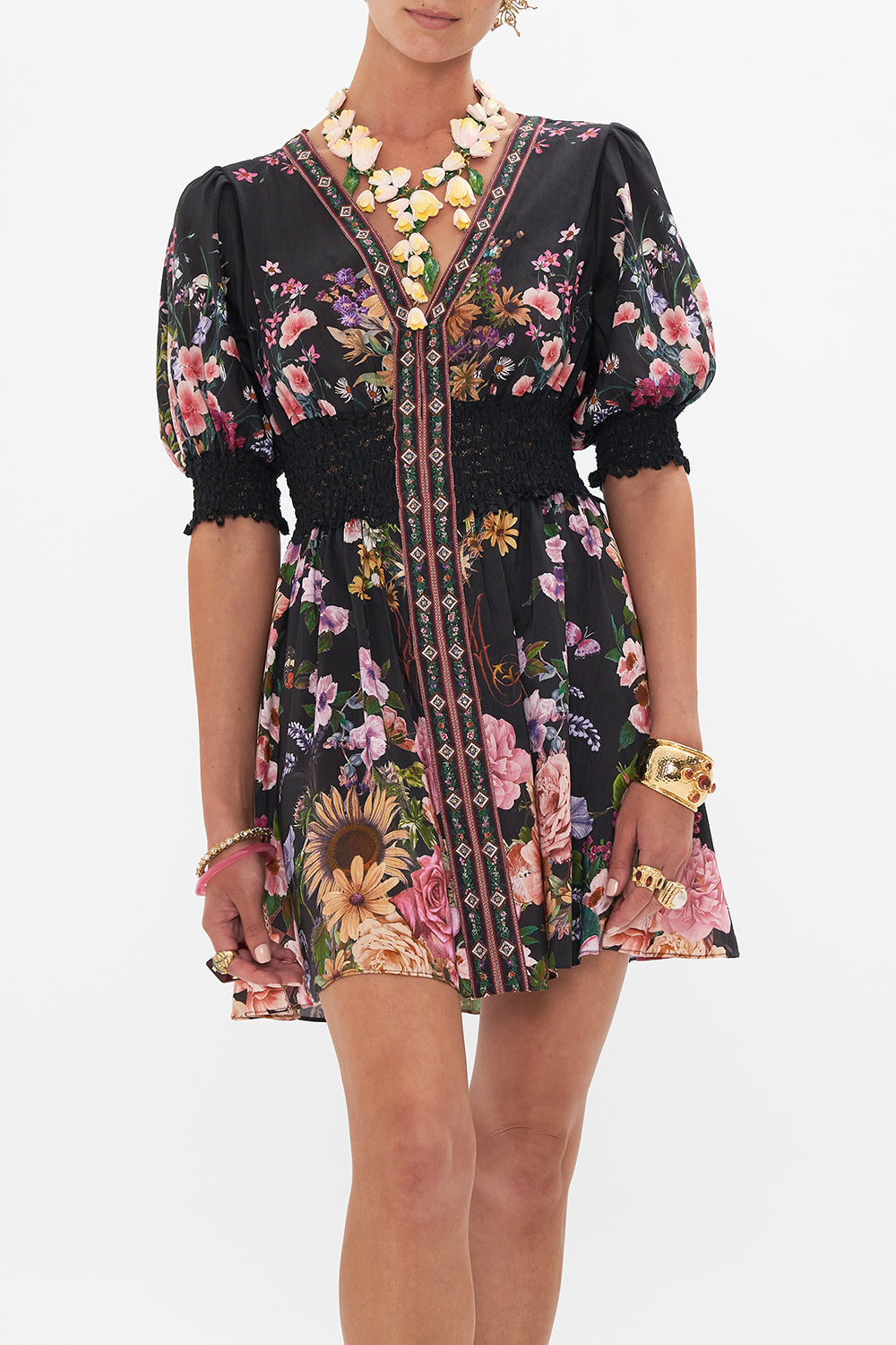 Crop view of model wearing CAMILLA silk mini dress in Letters From A Vineyard print