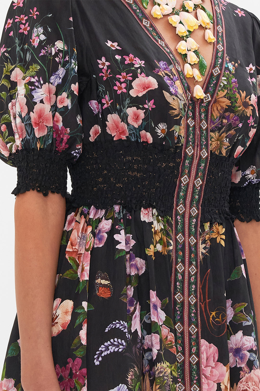 Detail view of model wearing CAMILLA silk mini dress in Letters From A Vineyard print