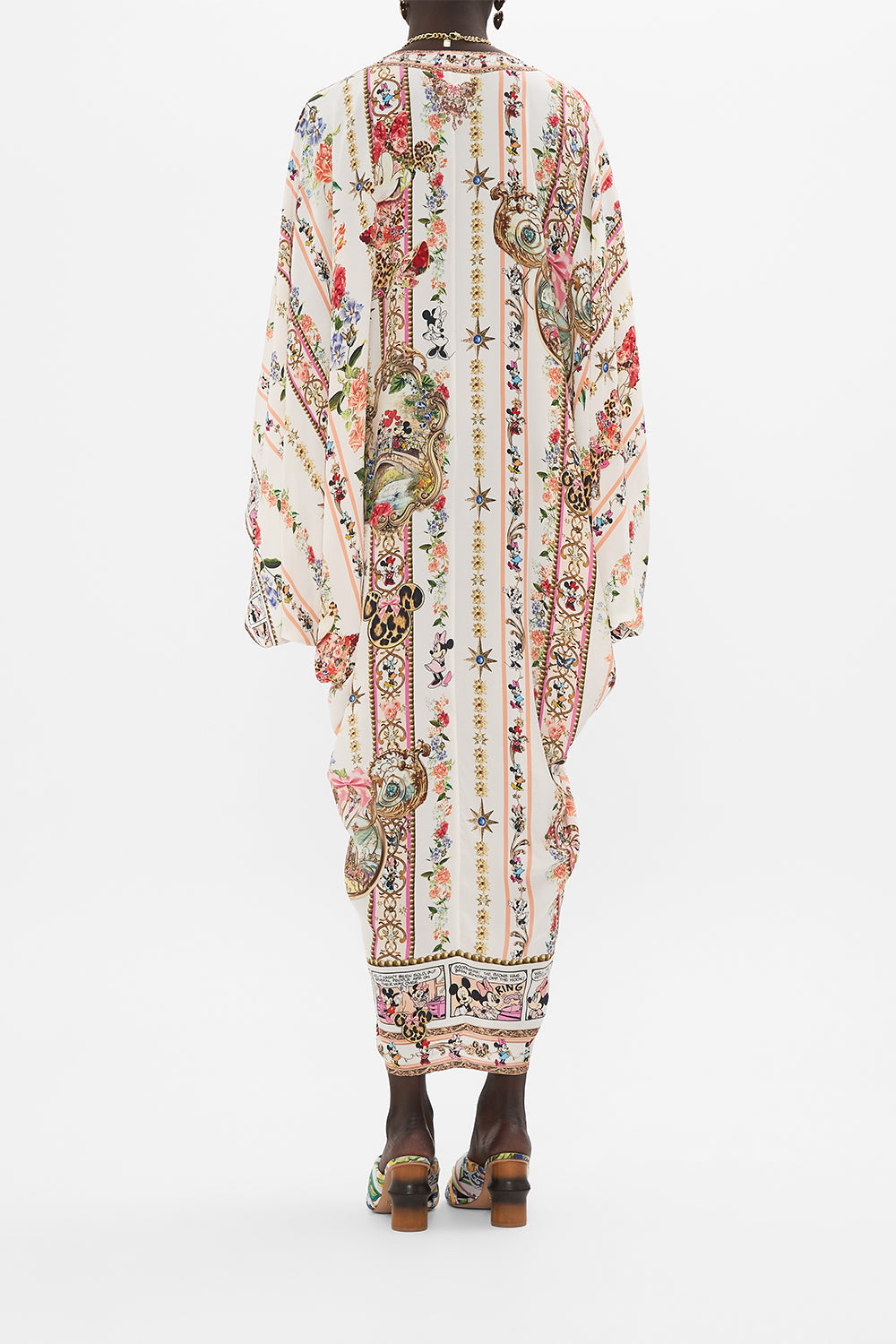 Back view of model wearing Disney x CAMILLA silk kaftan in Minnie Magic Forever print