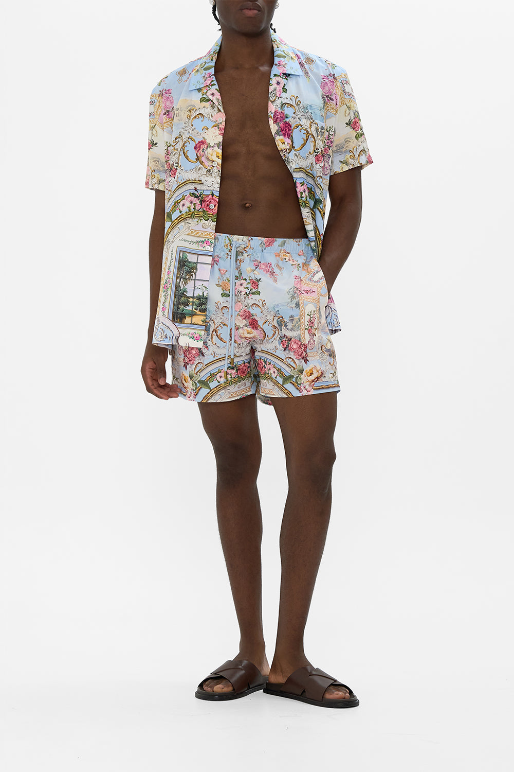 The CAMILLA MID LENGTH BOARDSHORT WITH ELASTIC WAIST TILED IN TIME in our  print.