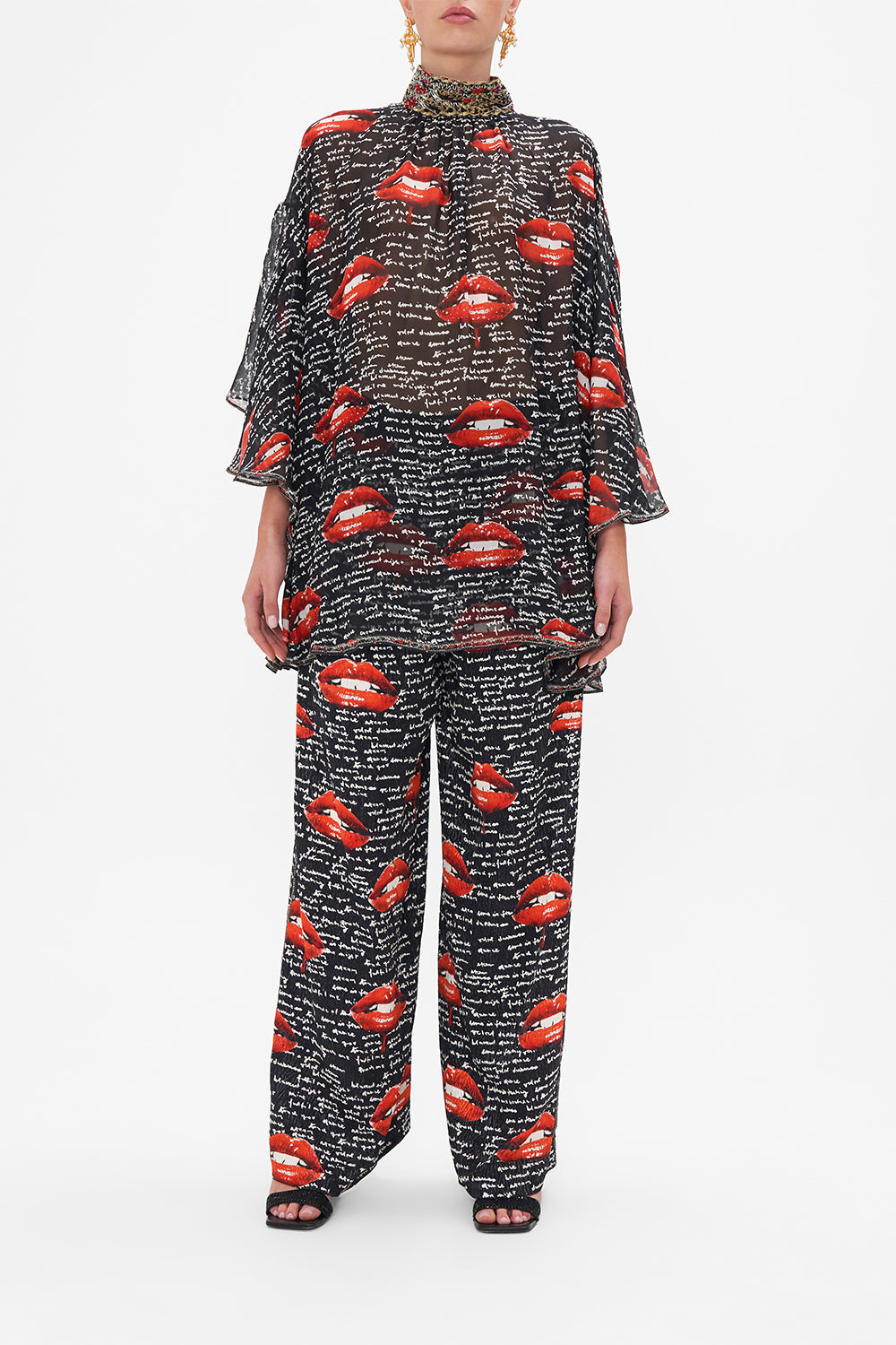 Front view of model wearing CAMILLA black silk blouse in Chaos Magic print 