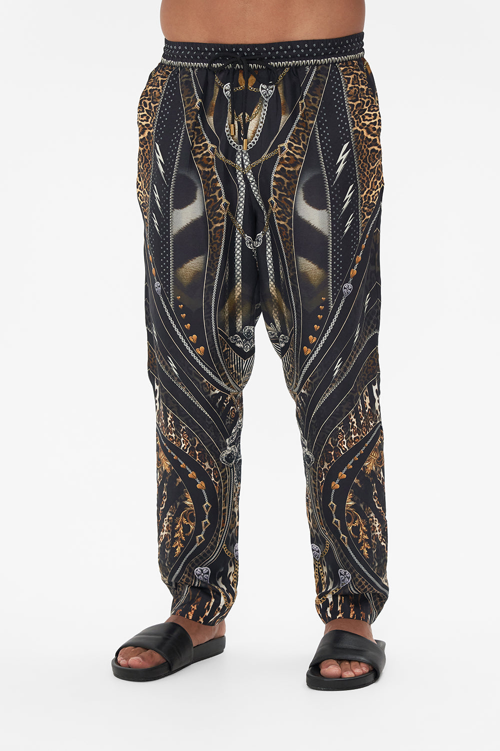 Crop view of model wearing Hotel Franks by CAMILLA mens pants in Chaos In The Cosmos animal print 
