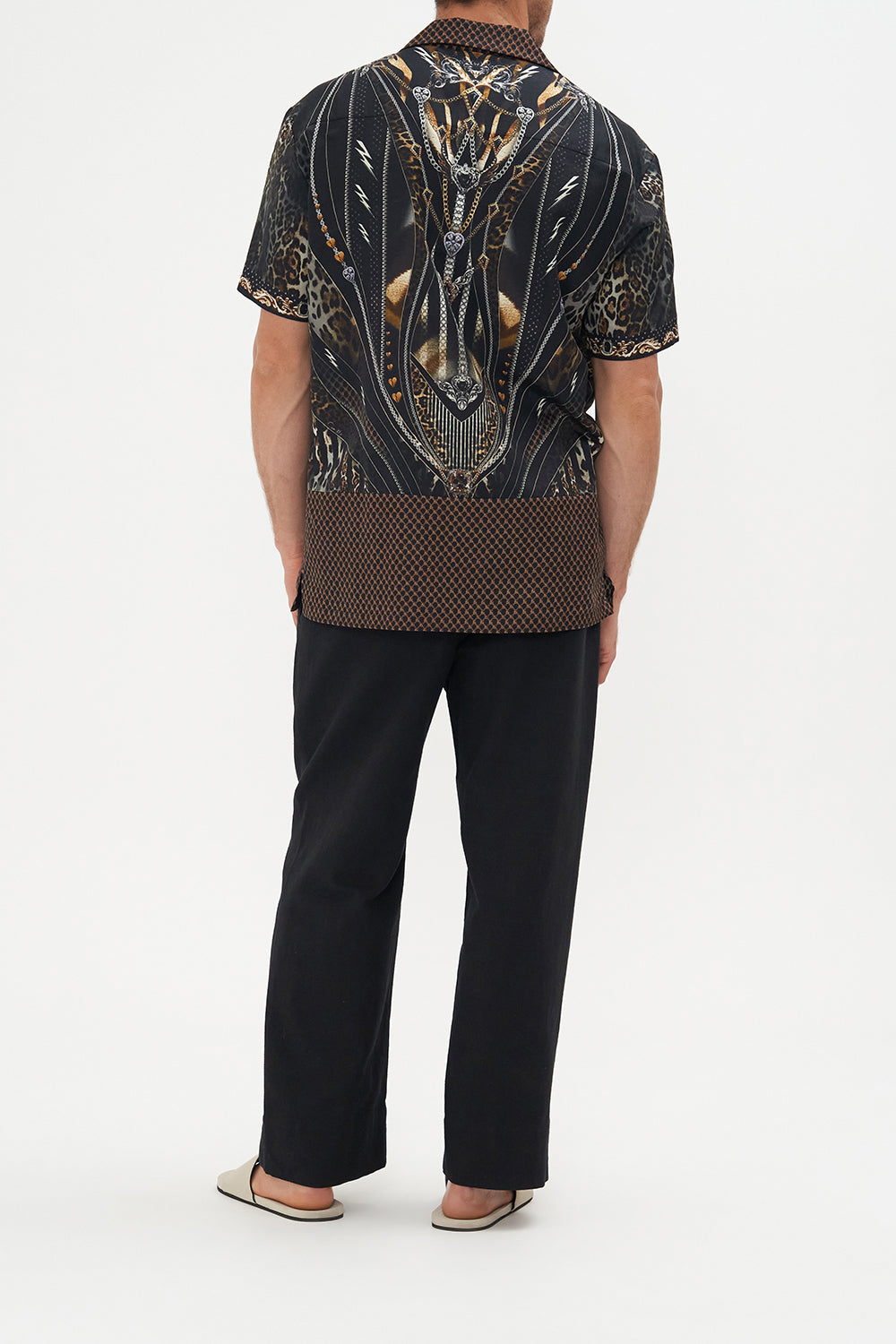 Back view of model wearing Hotel Franks by CAMILLA mens short sleeve camp collar shirt in Chaos in The Cosmos animal print 