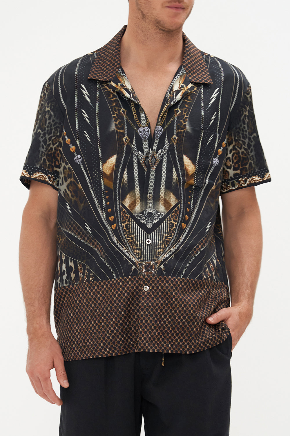 Crop view of model wearing Hotel Franks by CAMILLA mens short sleeve campp collar shirt in Chaos in The Cosmos animal print 