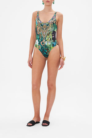 Front view of model wearing CAMILLA green one piece swimsuit in Sing My Song print