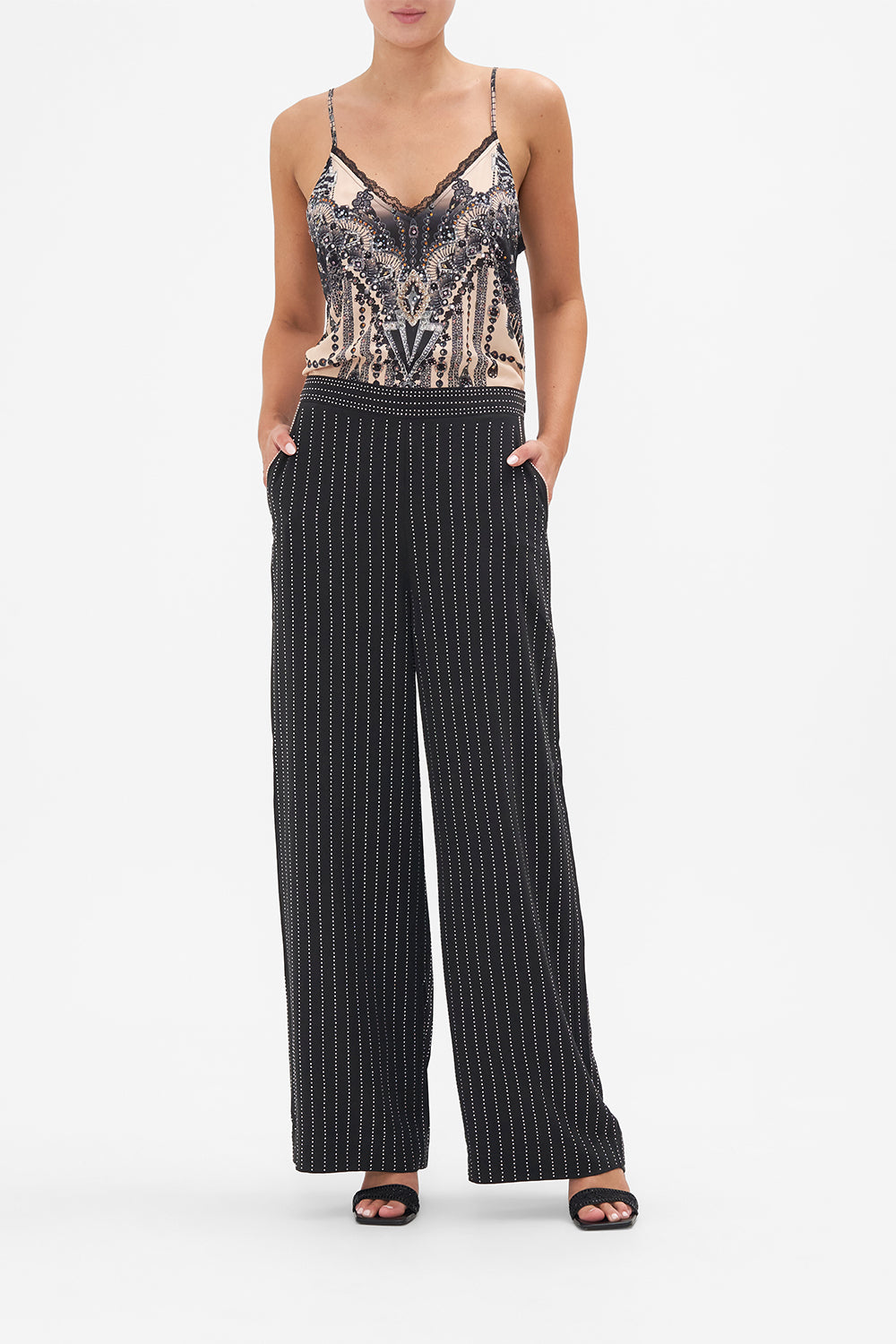 Front view of model wearing CAMILLA floral silk pants in Curtain Call Chaos print