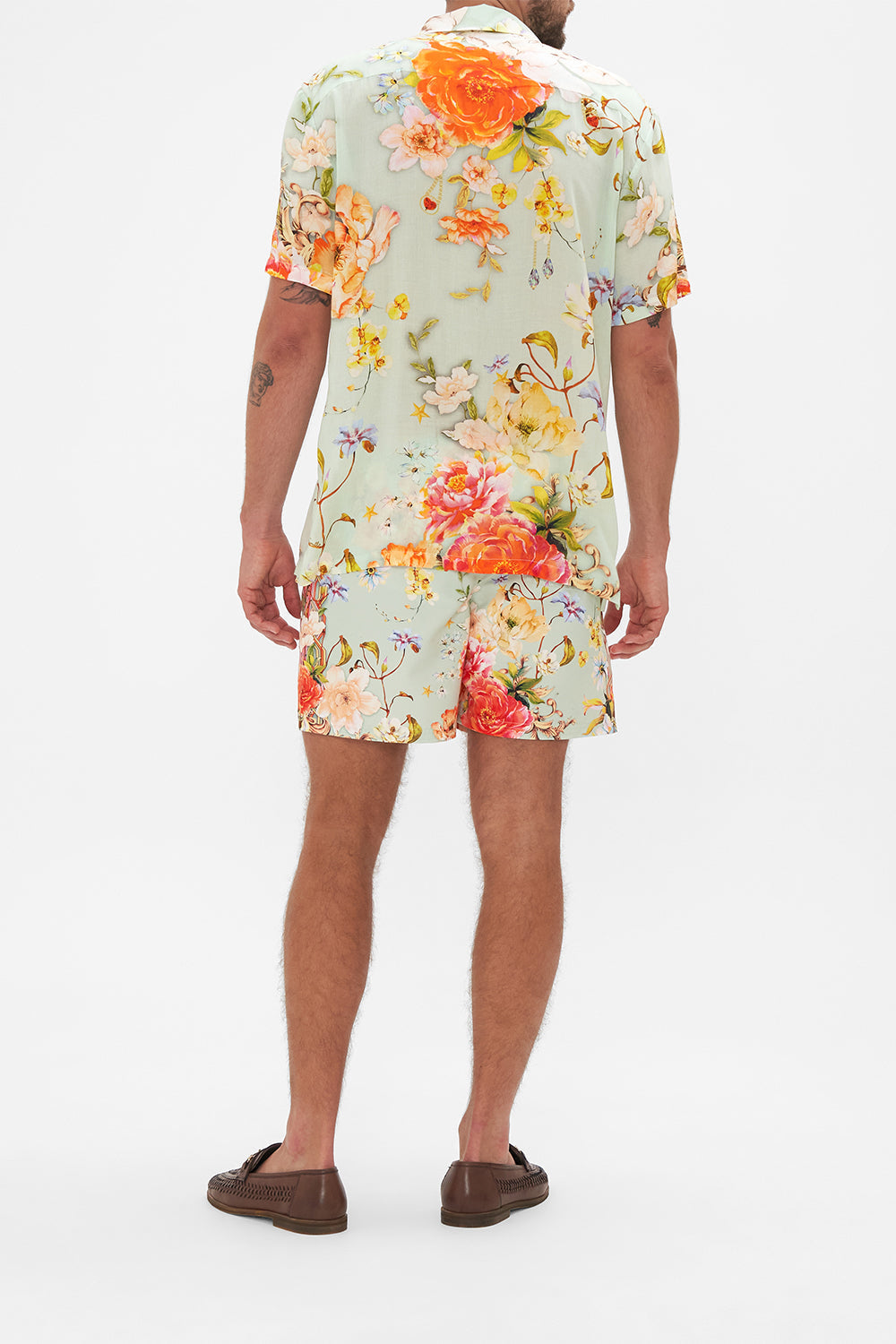 Back view of model wearing Hotel Franks by CAMILLA mens floral short sleeved camp collared shirt in Talk The Walk print