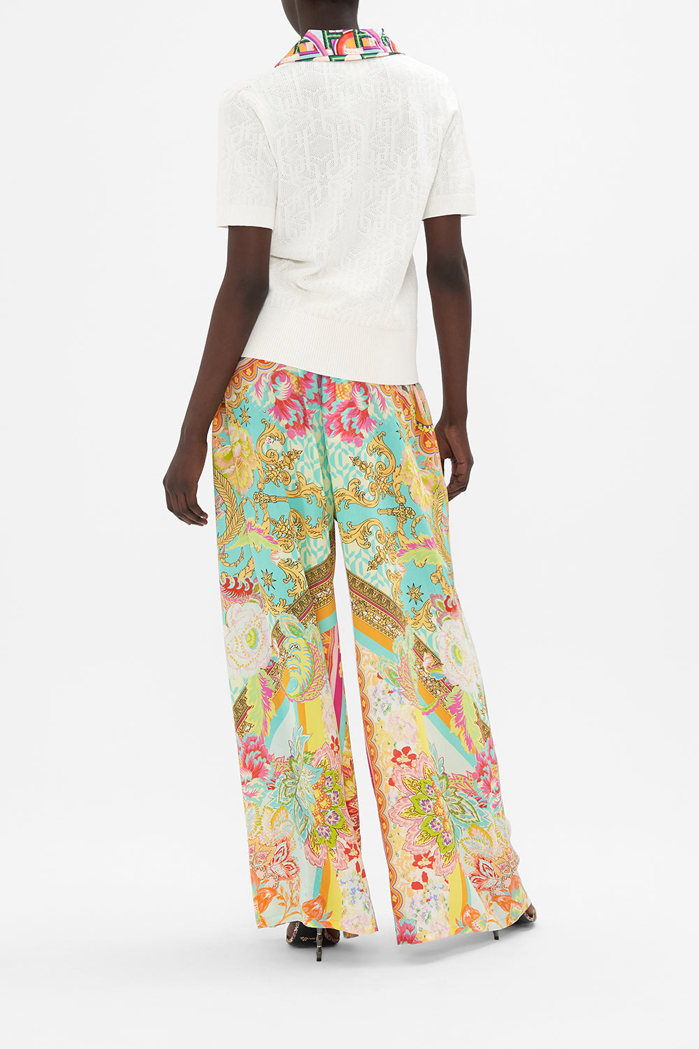 Back view of model wearing CAMILLA white knit polo  top in An Italian Welcome print