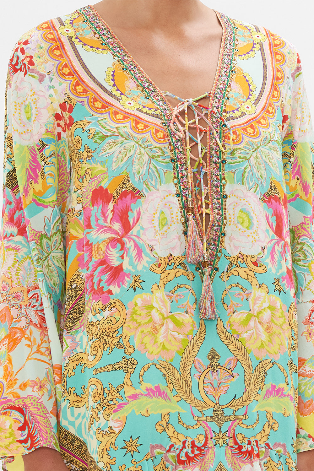 Detail view of model wearing CAMILLA silk mini dress with high low hem in An Italian Welcome print 