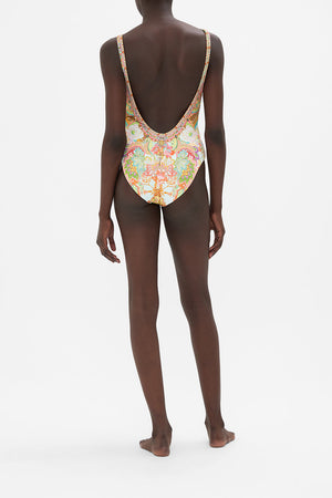 Side view of model wearing CAMILLA swimwear reversible one piece swimsuit in An Italian Welcome print