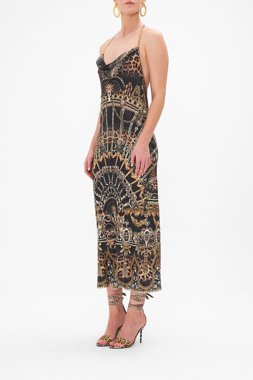 Side view of model wearing CAMILLA silk halter dress in Masked At Moonlight print