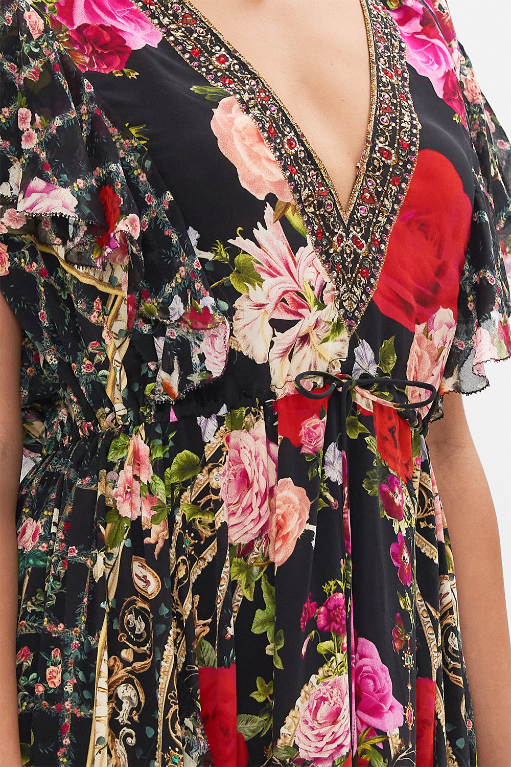 Detail view of model wearing CAMILLA designer floral ruffle dress in Reservation For Love print