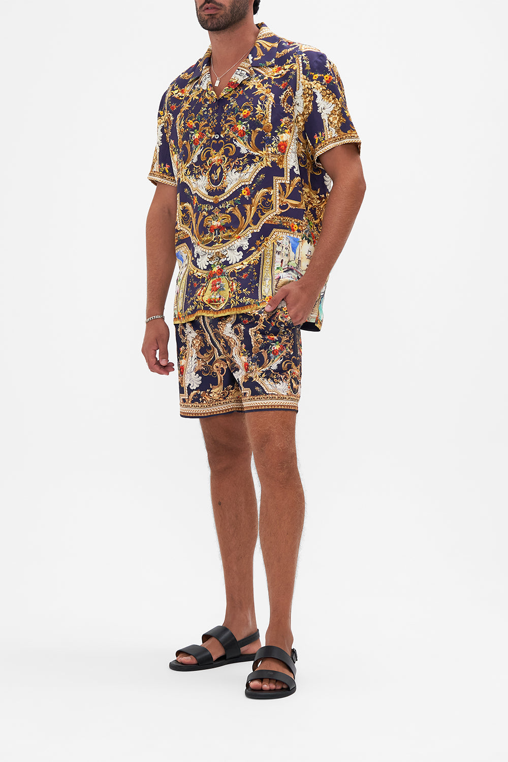 Side view of model wearing Hotel Franks By CAMILLA mens short sleeve camp collared shirt in  Venice Vignette print 