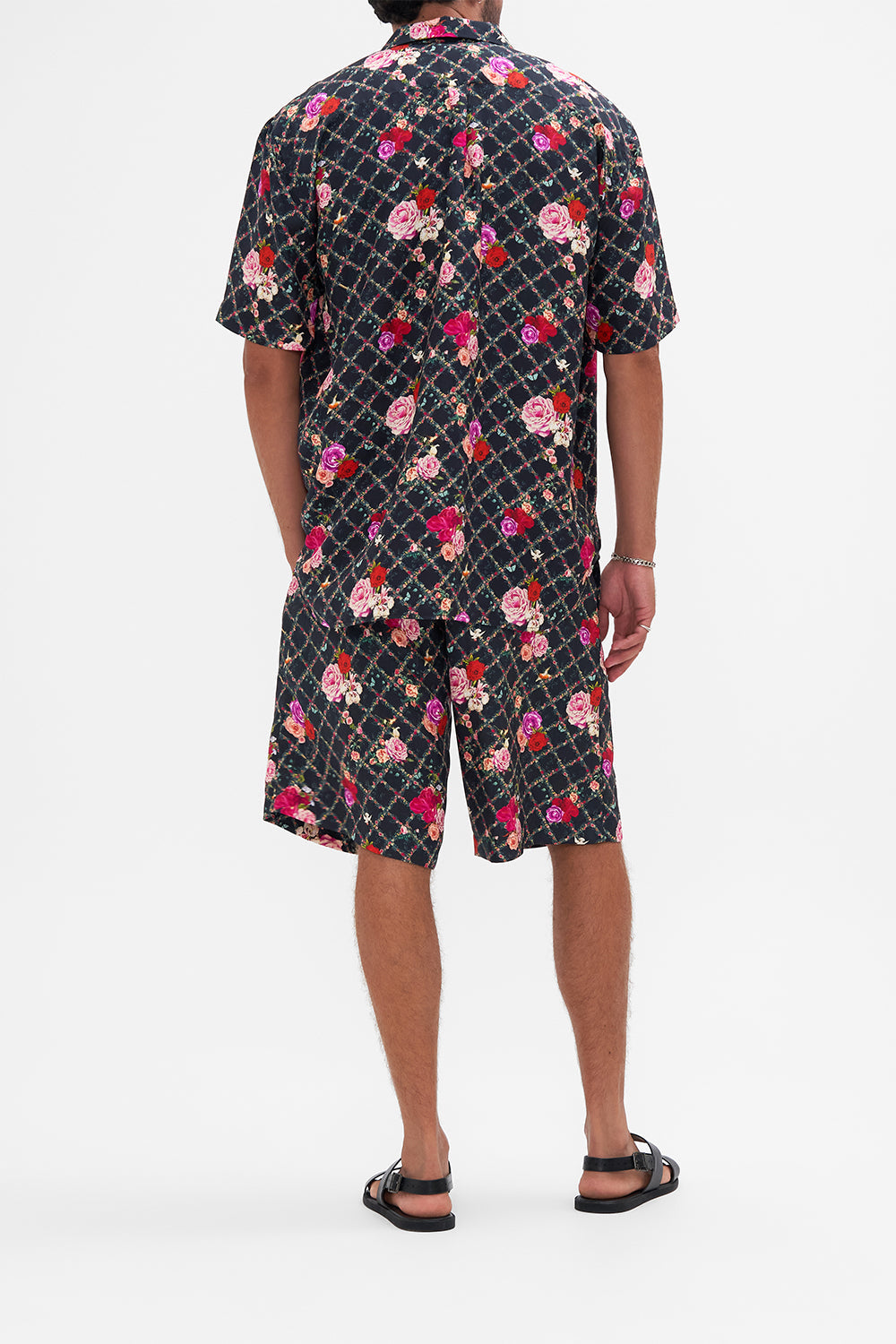Back view of model wearing CAMILLA silk short sleeve shirt in Reservation For Love print 