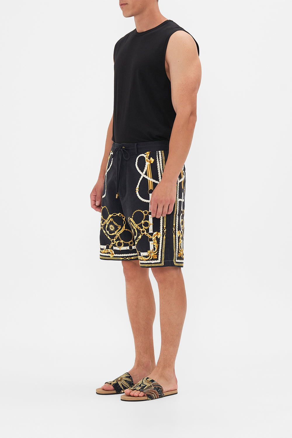Side view of model wearing Hotel Franks By CAMILLA mens boardshort in Coast To Coast print 
