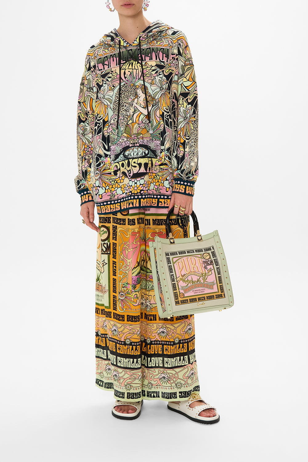 The CAMILLA NORTH SOUTH TOTE WITH SMOOTH HANDLE LETS CHASE RAINBOWS in our  print.