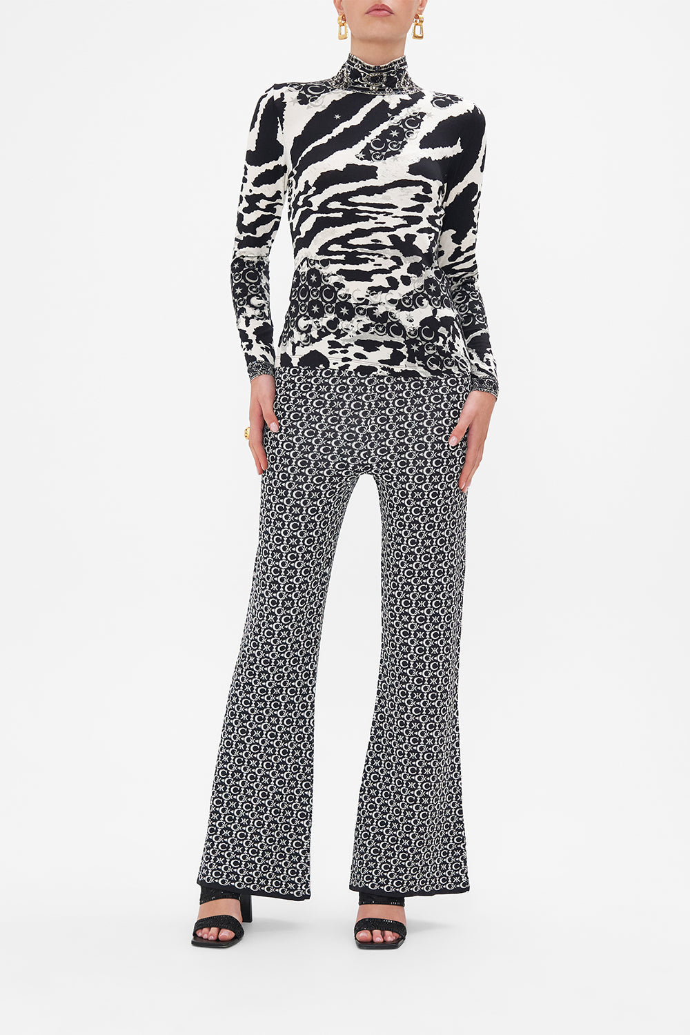 Front view of model wearing CAMILLA turtleneck top in black and white Feline Fantasy print