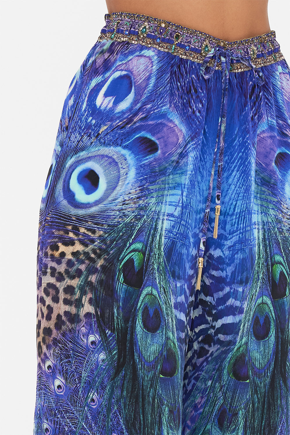 Detail view of model wearing CAMILLA silk pants in Peacock Rock print