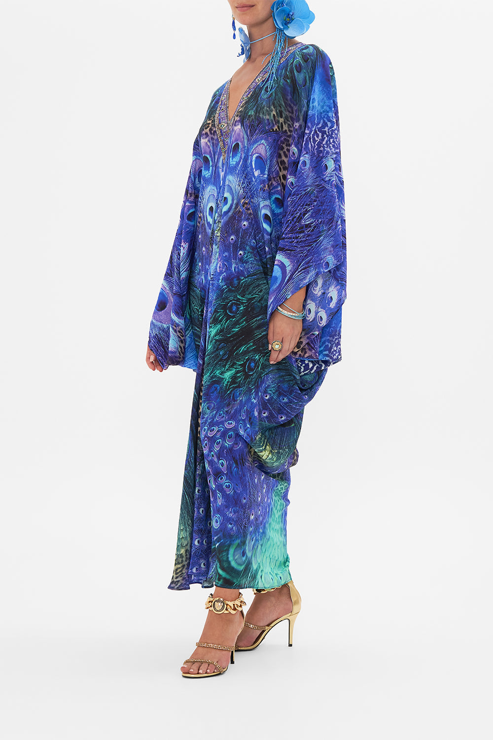 Side view of model wearing CAMILLA silk kaftan in Peacock Rock print