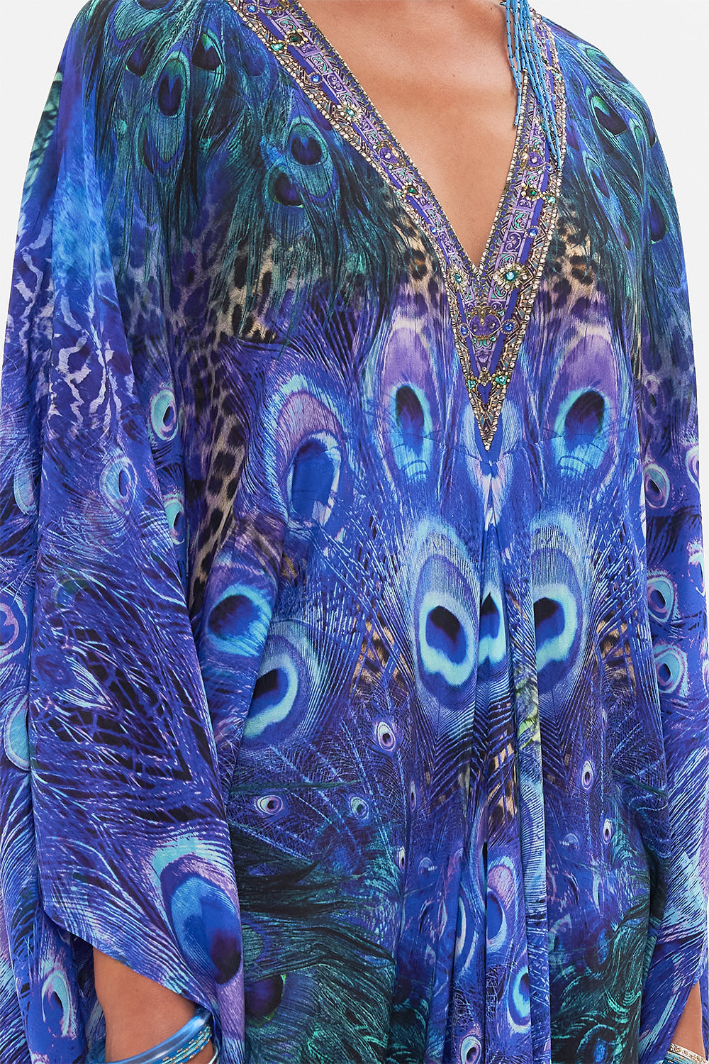 Detail view of model wearing CAMILLA silk kaftan in Peacock Rock print