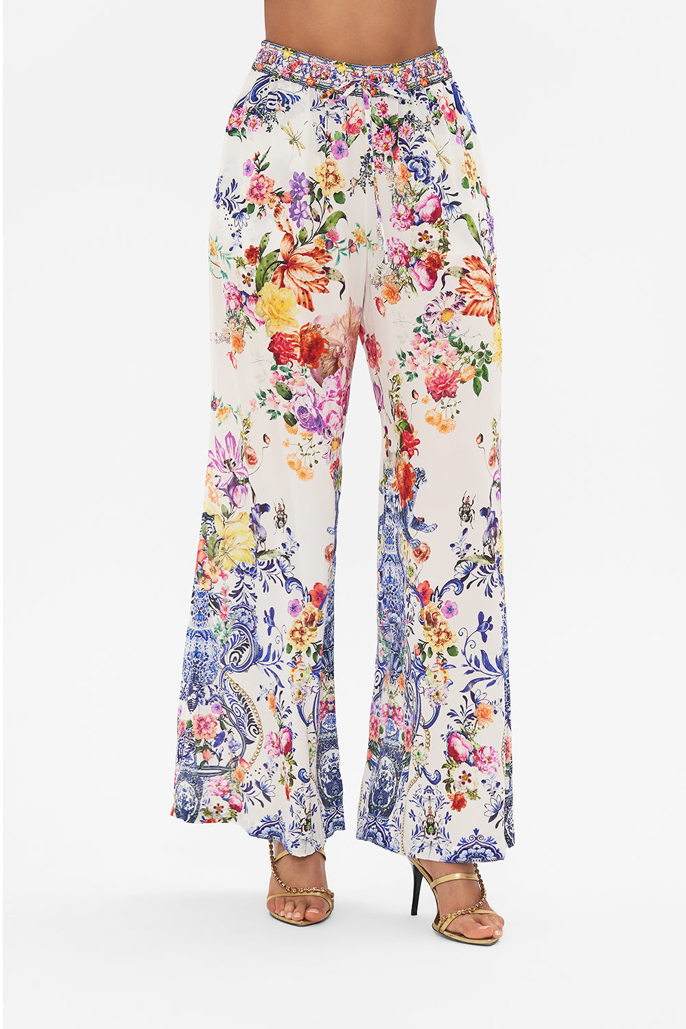 Crop view of model wearing CAMILLA silk pants in Dutch Is Life print