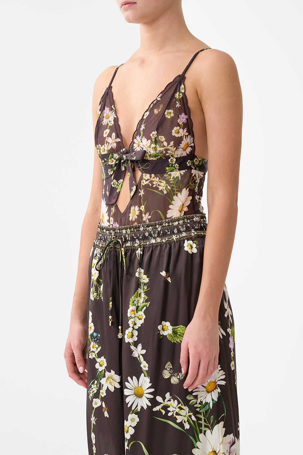 The CAMILLA SCALLOPED EDGE TRIANGLE BODYSUIT WITH BOW FRONT DISH IT, DAISY in our  print.
