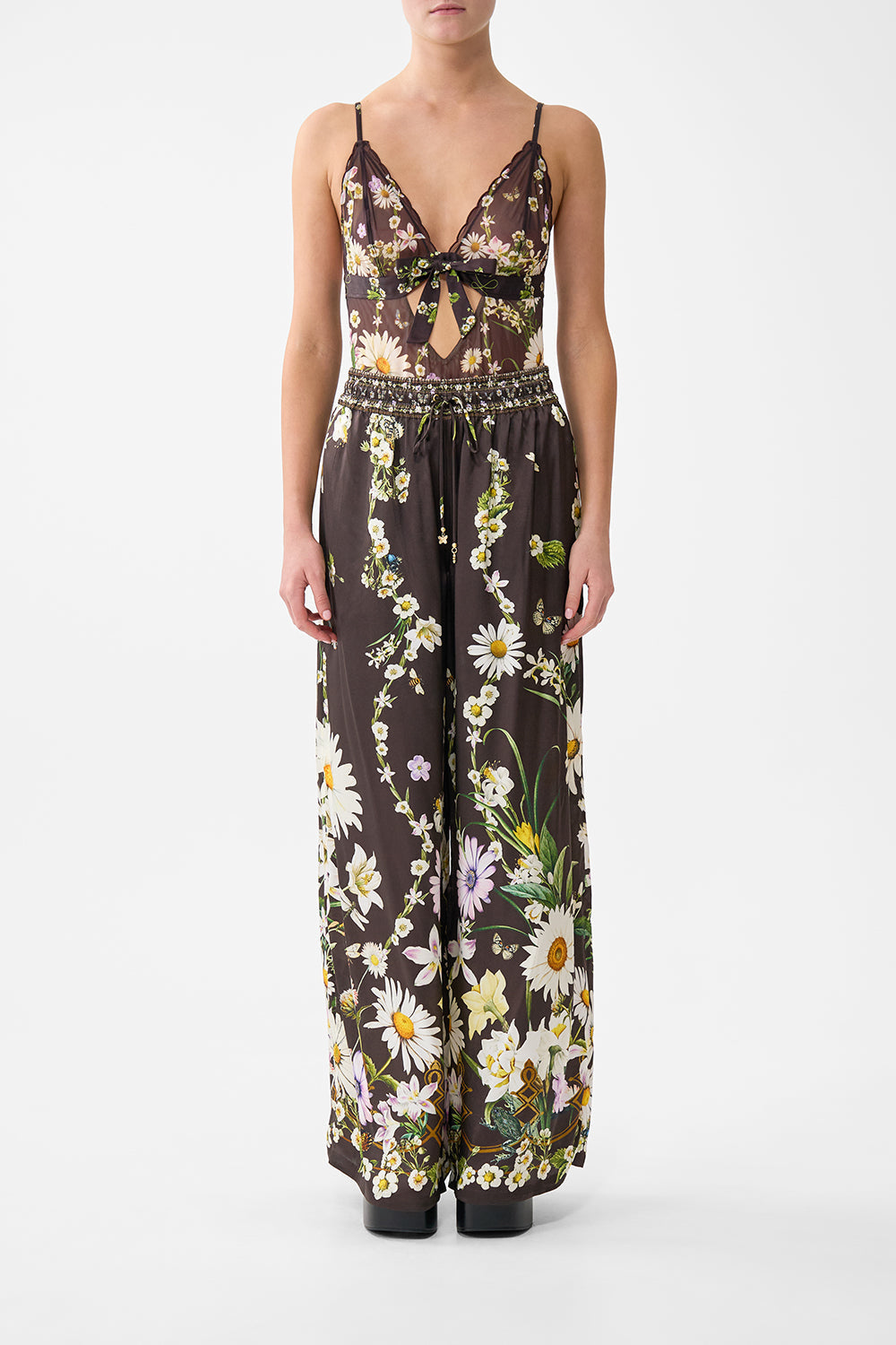 The CAMILLA SCALLOPED EDGE TRIANGLE BODYSUIT WITH BOW FRONT DISH IT, DAISY in our DISH IT, DAISY print.