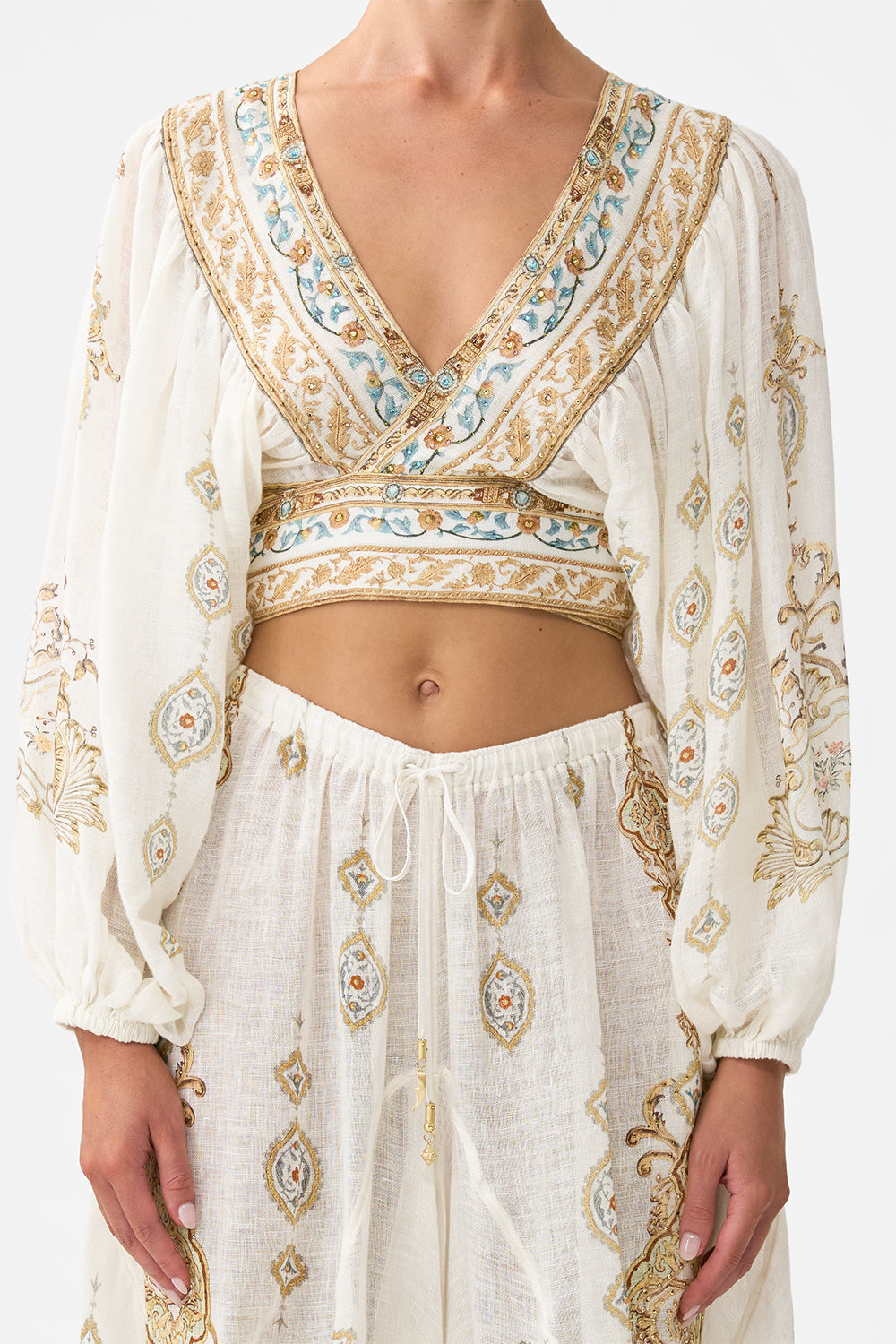 The CAMILLA CROPPED BLOUSON SLEEVE TIE FRONT TOP OTTOMAN DYNASTY in our  print.