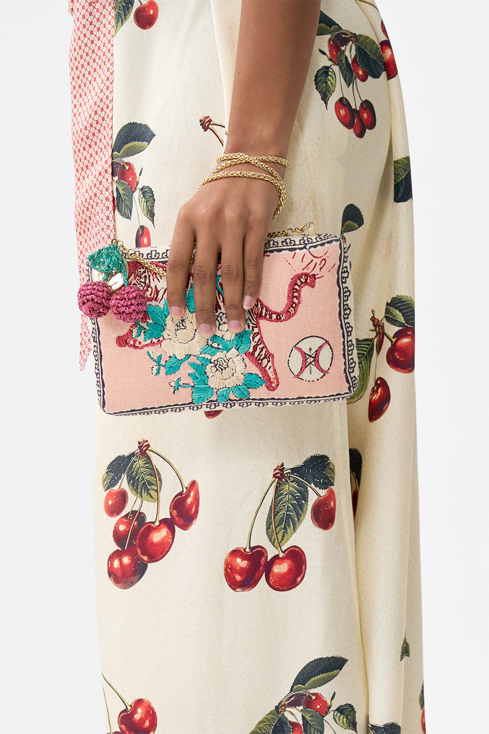 The CAMILLA hardcase clutch with raffia detail from our print notes from the road