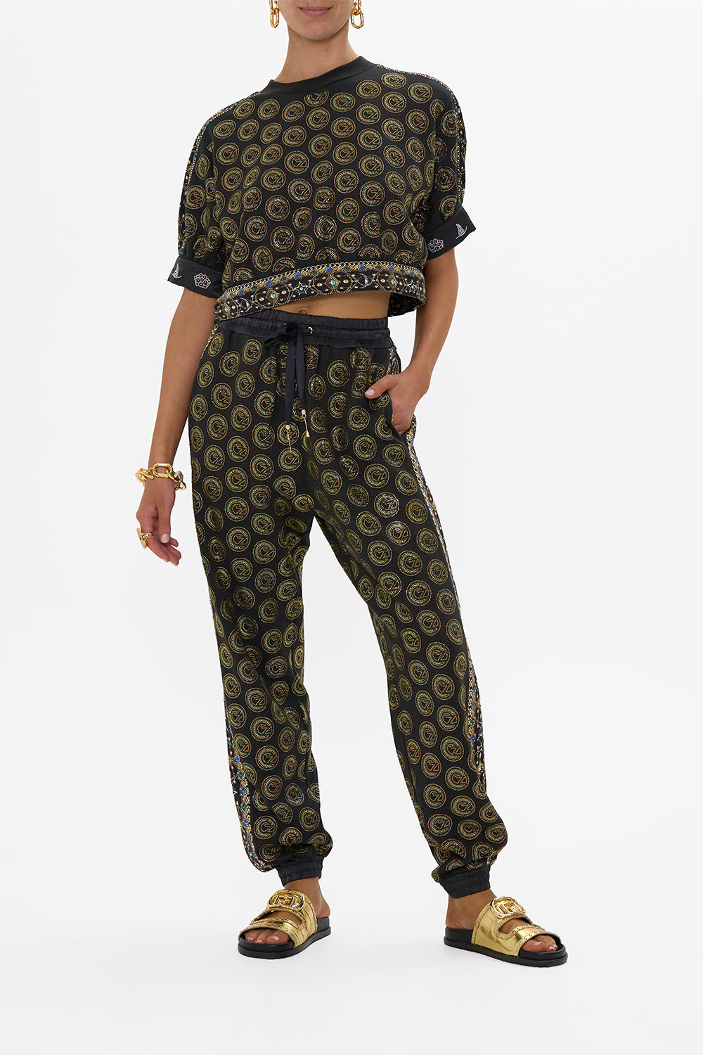 The CAMILLA JERSEY TRACK PANT WITH SIDE PANELS DEFY GRAVITY in our DEFY GRAVITY print.
