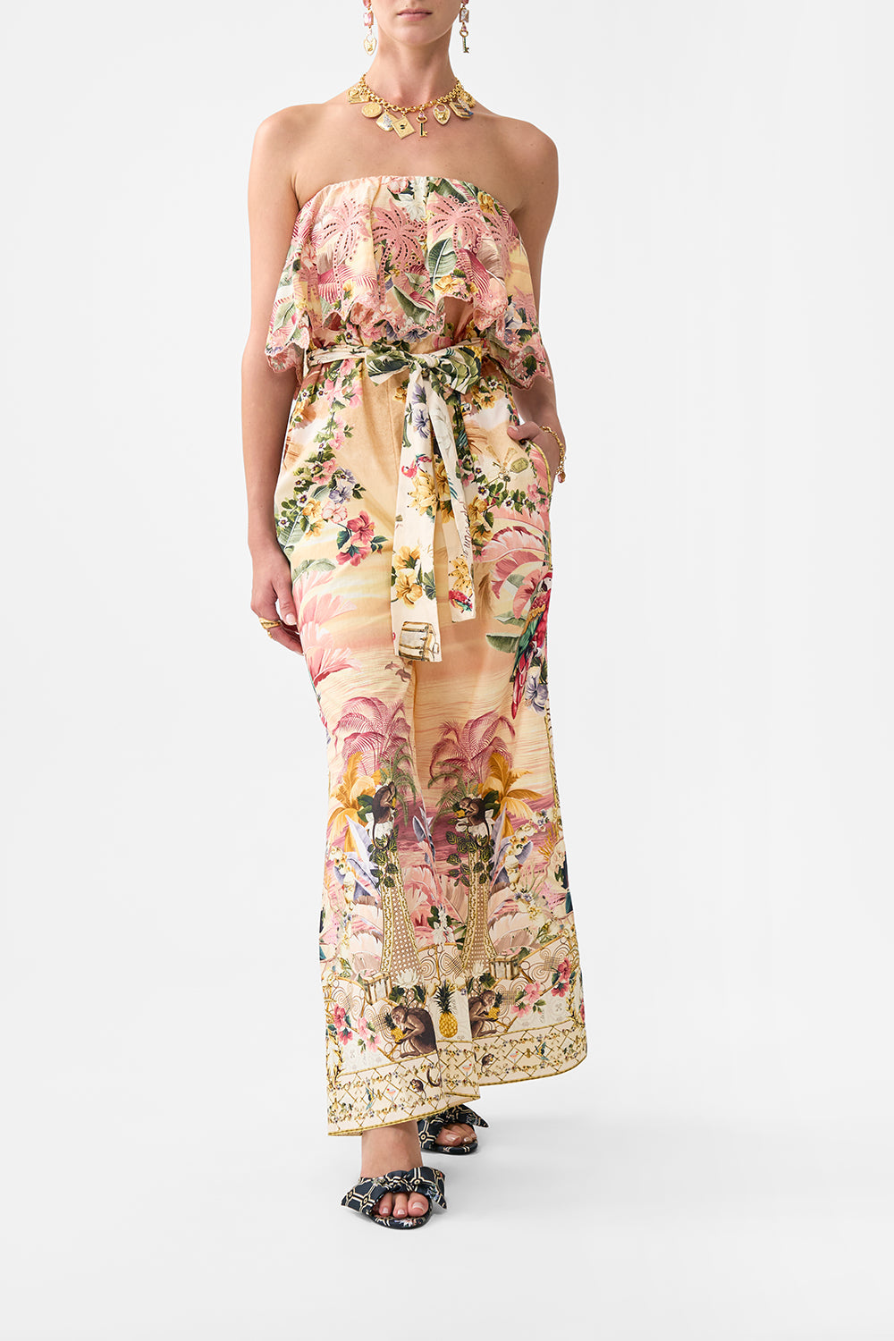 The CAMILLA STRAPLESS JUMPSUIT WITH FRILL WELCOME TO THE WHITE LOTUS in our WELCOME TO THE WHITE LOTUS print.