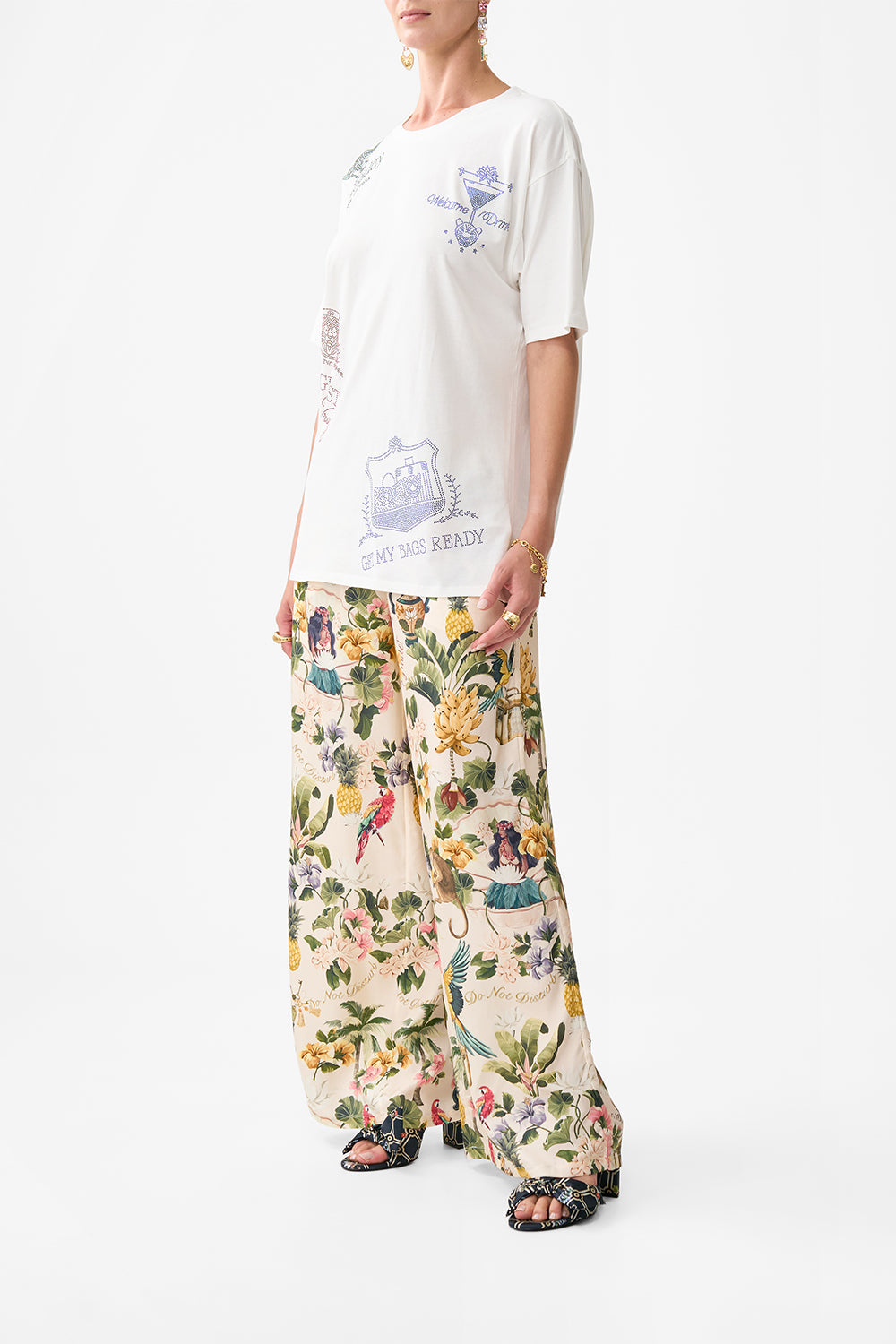 The CAMILLA OVERSIZED BAND TEE WELCOME TO THE WHITE LOTUS in our  print.