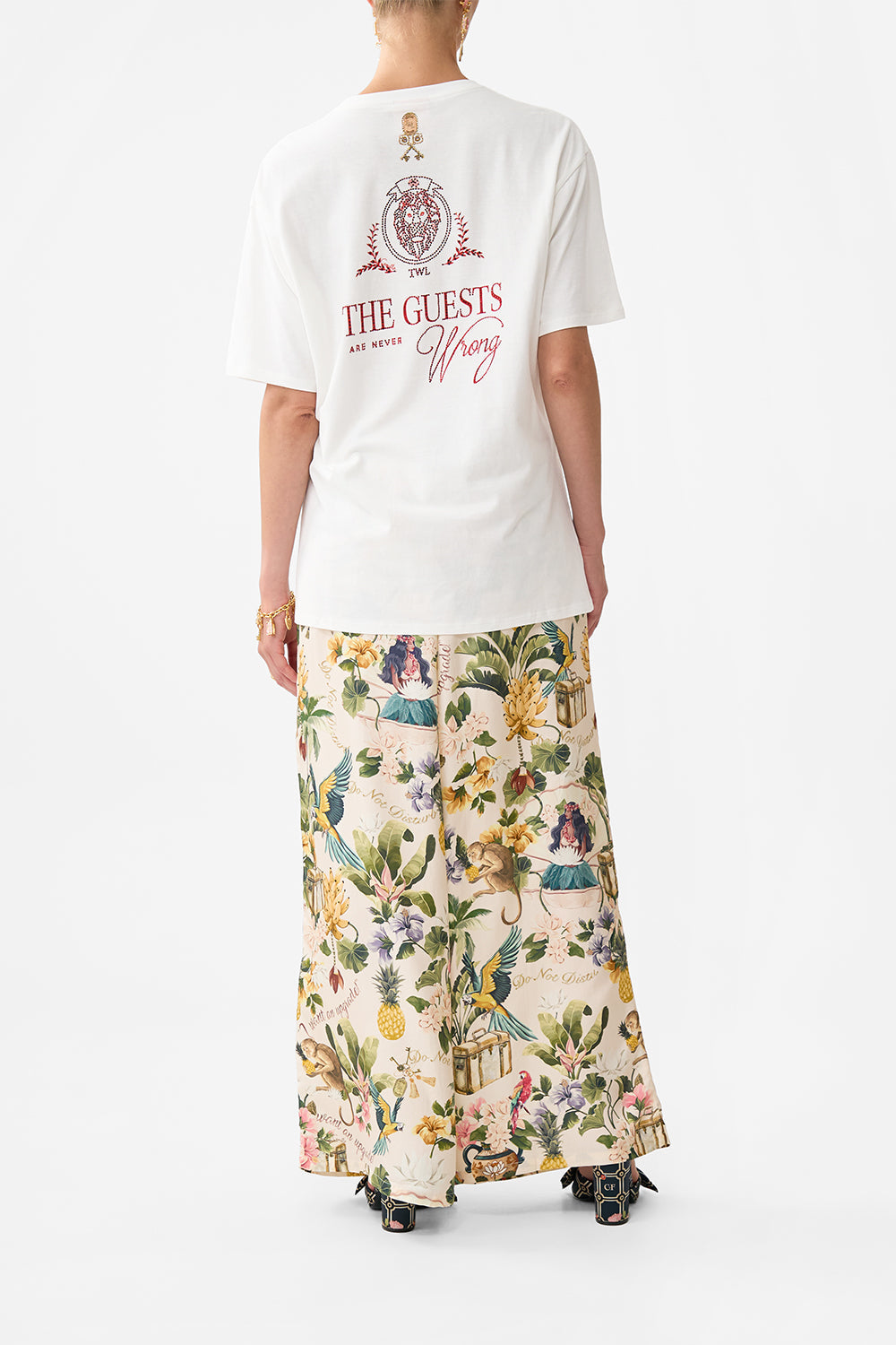 The CAMILLA OVERSIZED BAND TEE WELCOME TO THE WHITE LOTUS in our  print.