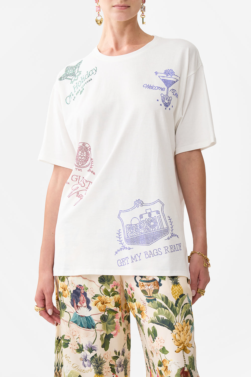 The CAMILLA OVERSIZED BAND TEE WELCOME TO THE WHITE LOTUS in our  print.