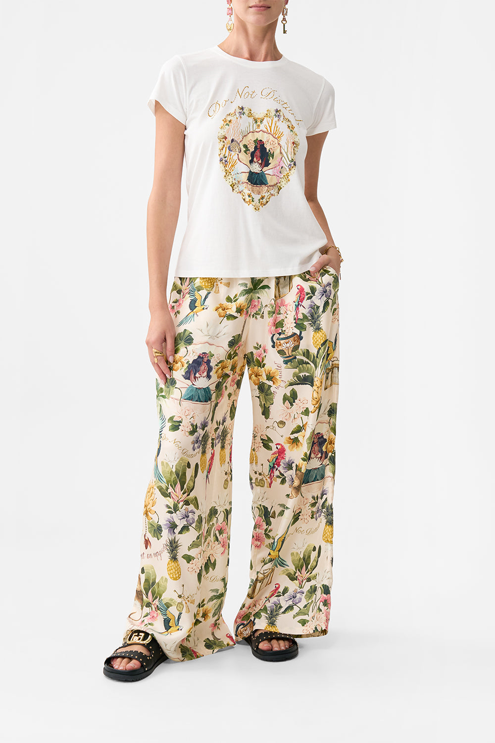 The CAMILLA SLIM FIT ROUND NECK T-SHIRT WELCOME TO THE WHITE LOTUS in our WELCOME TO THE WHITE LOTUS print.