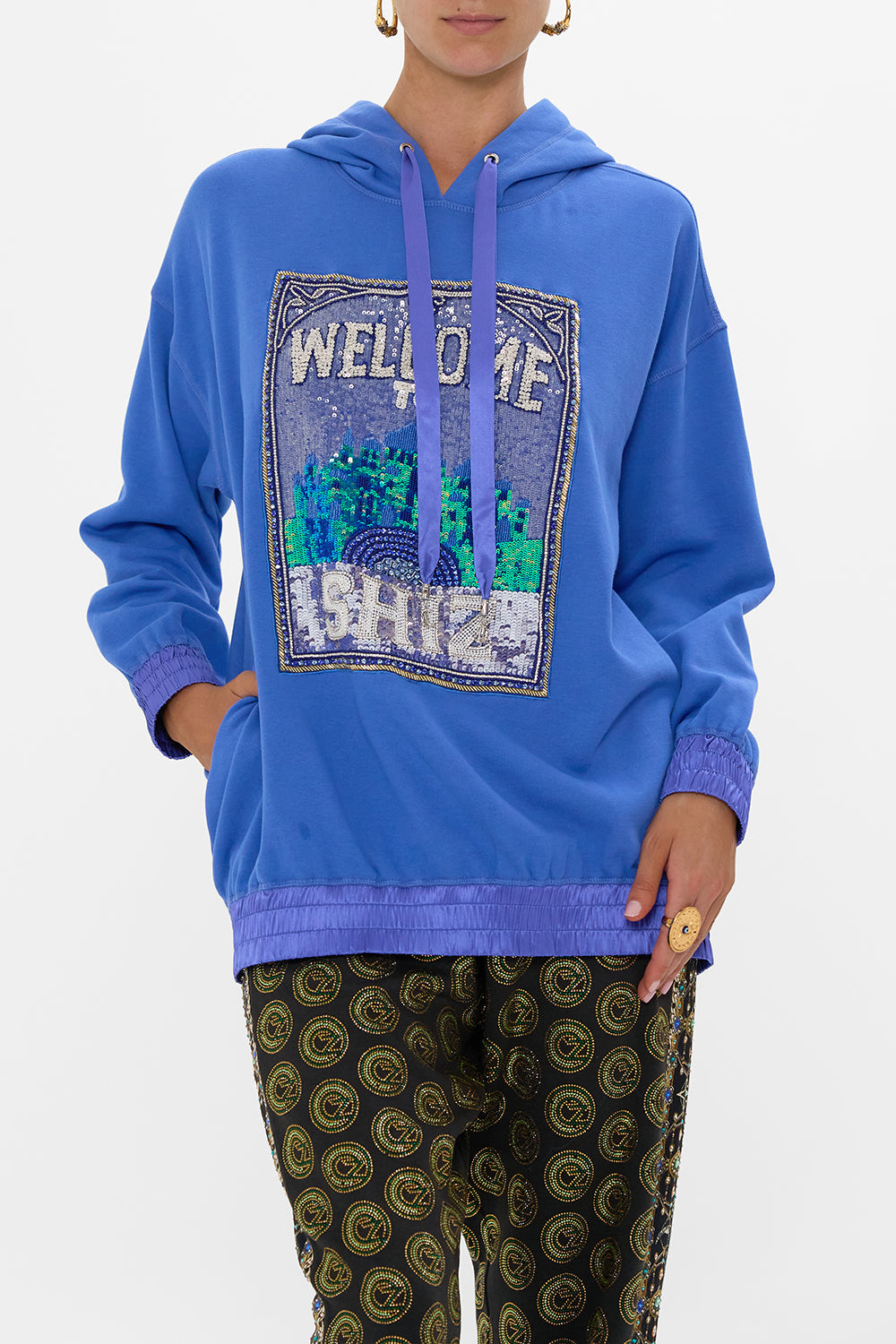 The CAMILLA SILK BAND OVERSIZED HOODIE WITH POCKETS- BLUE DEFY GRAVITY in our  print.