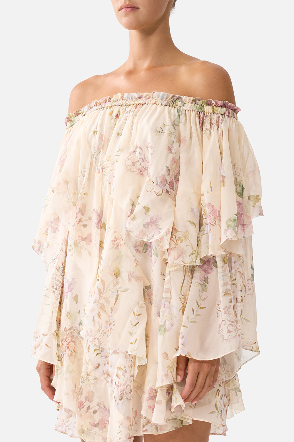The CAMILLA OFF SHOULDER ASSYMETRIC RUFFLE DRESS ADORNED IN ARANJUEZ in our  print.