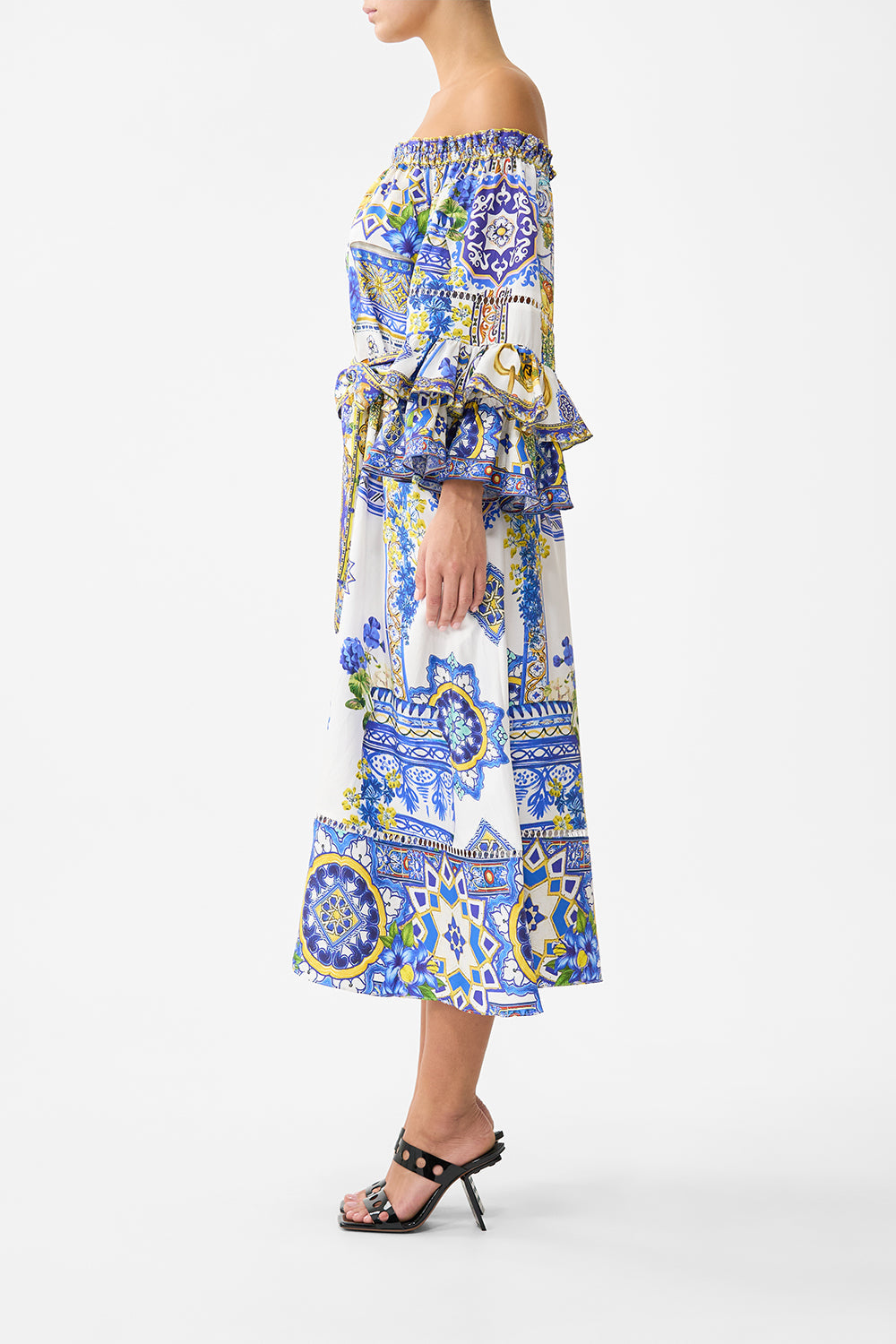 The CAMILLA off shoulder midi dress with frill sleeve in our print España Nirvana. Side model view.